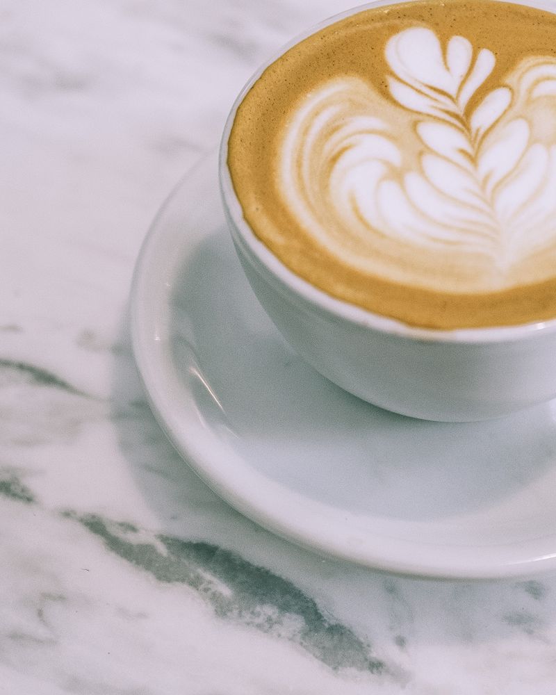 An overhead view of a cappuccino with latte art