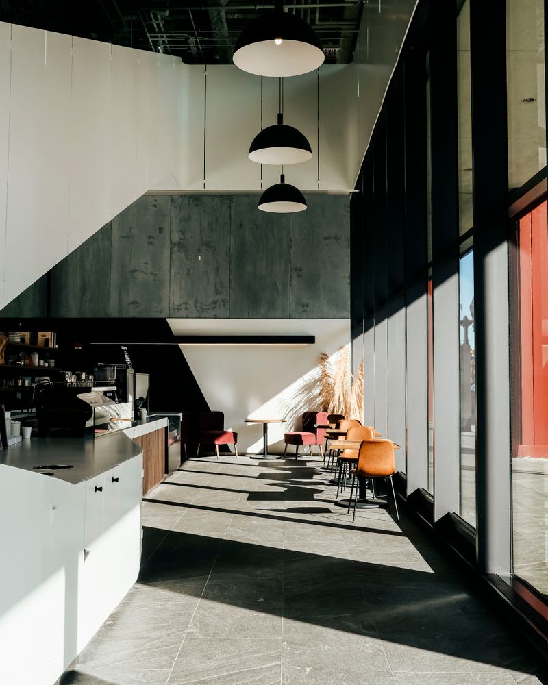 A sunlit, plant-filled café interior