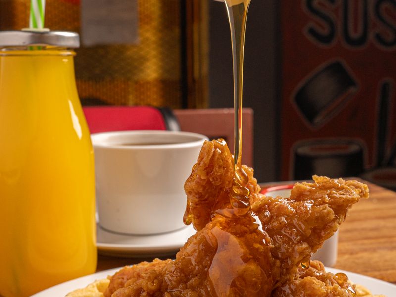 Buttermilk waffles drizzled with maple syrup